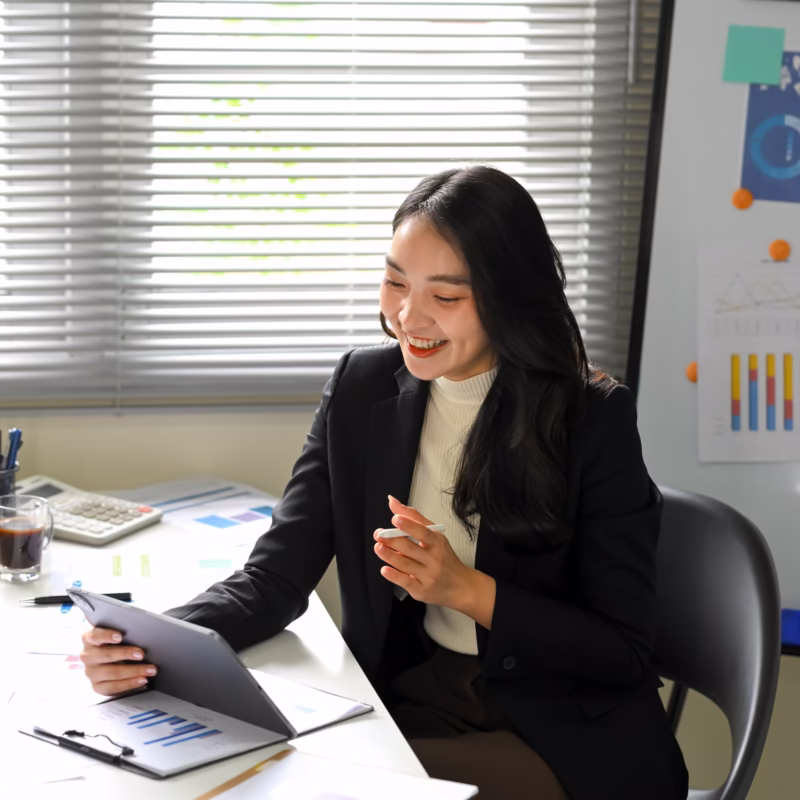 Business professional reviewing expense reports on a digital tablet, illustrating real-time HRIS and SAP SuccessFactors expense management integration.