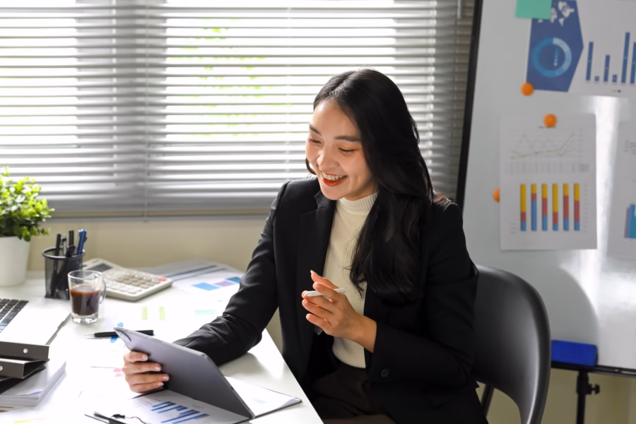 Business professional reviewing expense reports on a digital tablet, illustrating real-time HRIS and SAP SuccessFactors expense management integration.